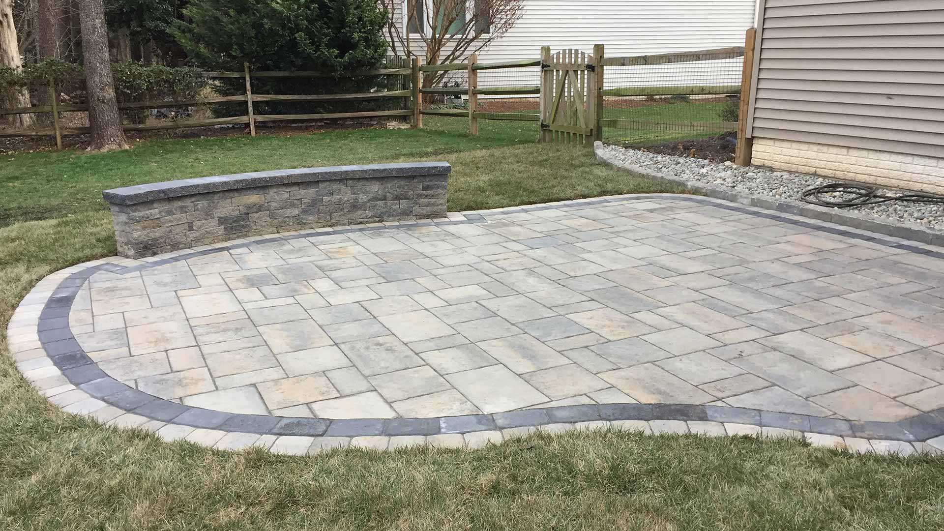 Custom stone patio and retaining wall installation in Bristow, VA.