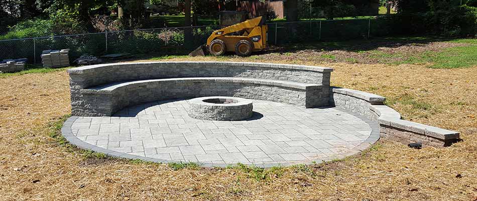 Custom stone seating wall and fire pit construction in Manassas, VA.