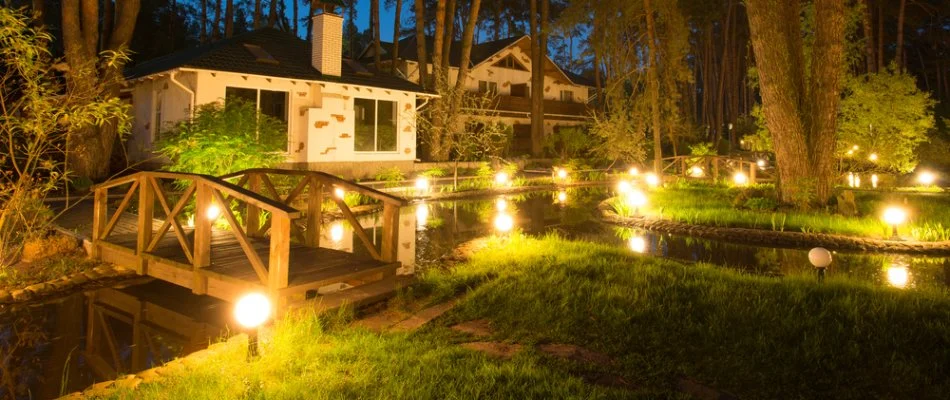 A property in Bristow, VA, with outdoor lighting around the landscape.