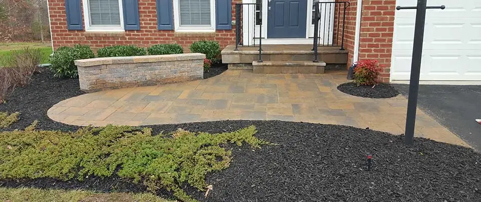 Custom patio, seating wall, and landscape installation for a Manassas, VA home.