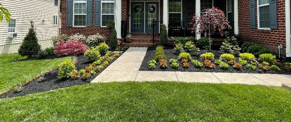 A property in Buckhall, VA, with green grass and landscape beds near a sidewalk.