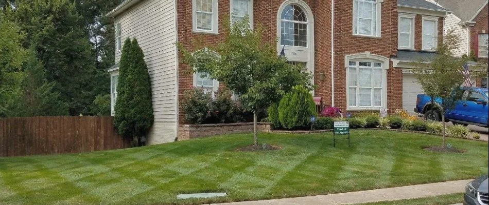 Green, healthy lawn in front of brick house in County Center, VA.