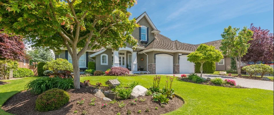 A home in Dale City, VA, with trees and shrubs.