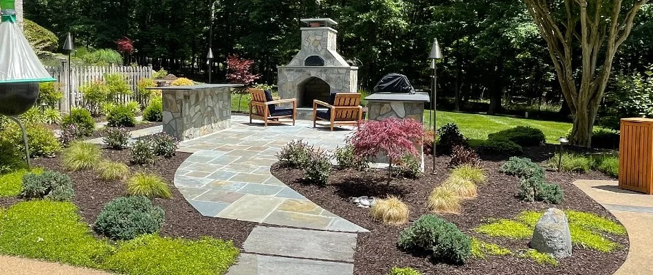 A patio with an outdoor fireplace on a property in Dale City, VA.