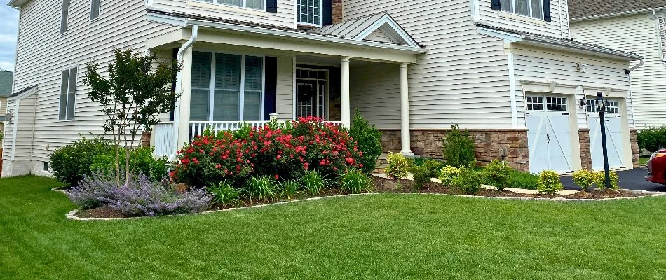 Landscape beds with colorful flowers on a property in Marumsco, VA.