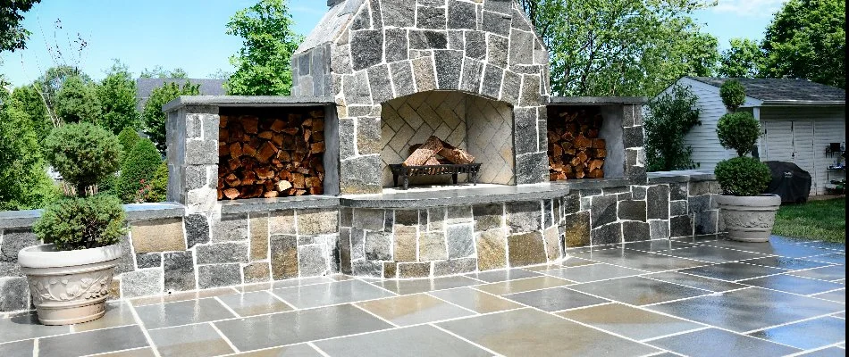 A wood-burning outdoor fireplace with a matching patio in Sudley, VA.